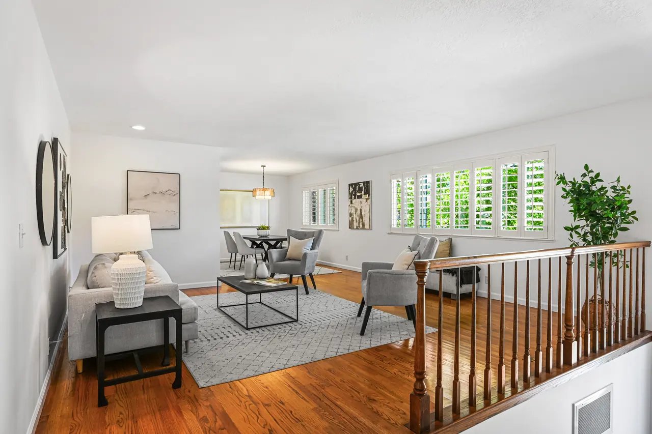 Living room with hardwood floors and a stair rail