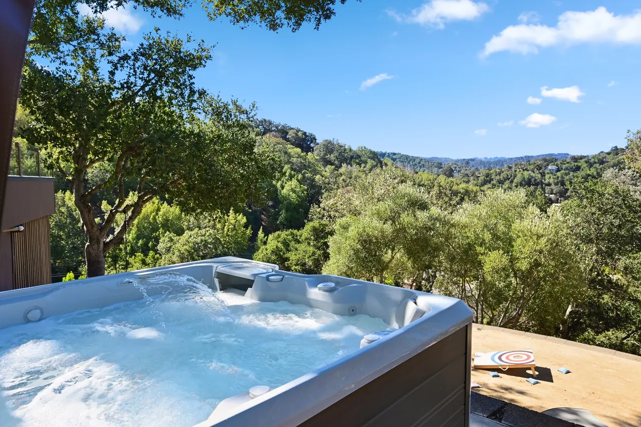 Hot tub on a terrace above an oak-covered valley